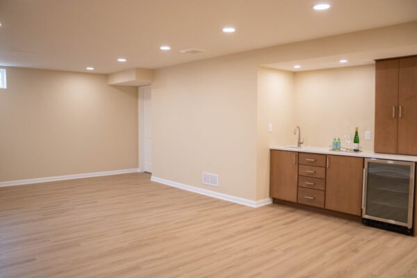 living room space with home bar kitchenette