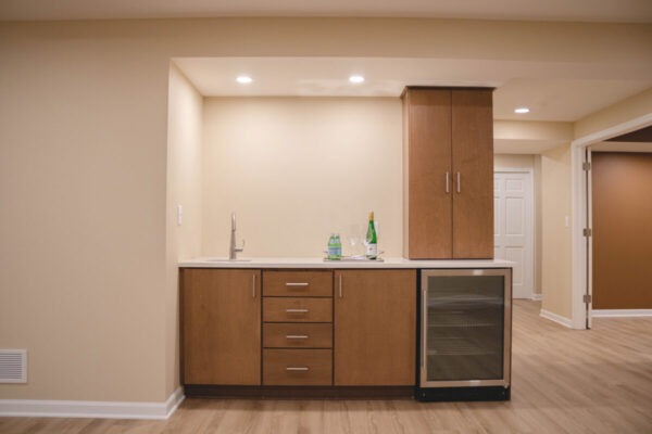 home bar kitchenette with wood cabinets